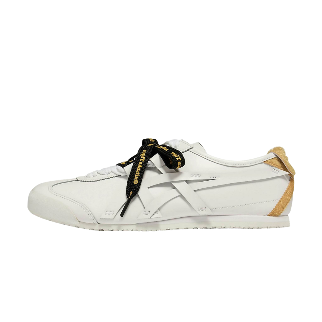 Onitsuka Tiger Mexico 66 New Year 2026 zijaanzicht, wit leer met goudkleurige hielcap en zwart-geel gestreepte veters